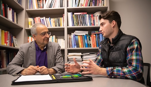 Business student and faculty member in a discussion. 